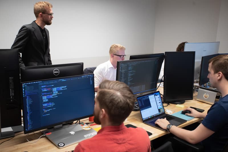 Kernel Technologies engineers working at multi-monitor workstations in the New York office